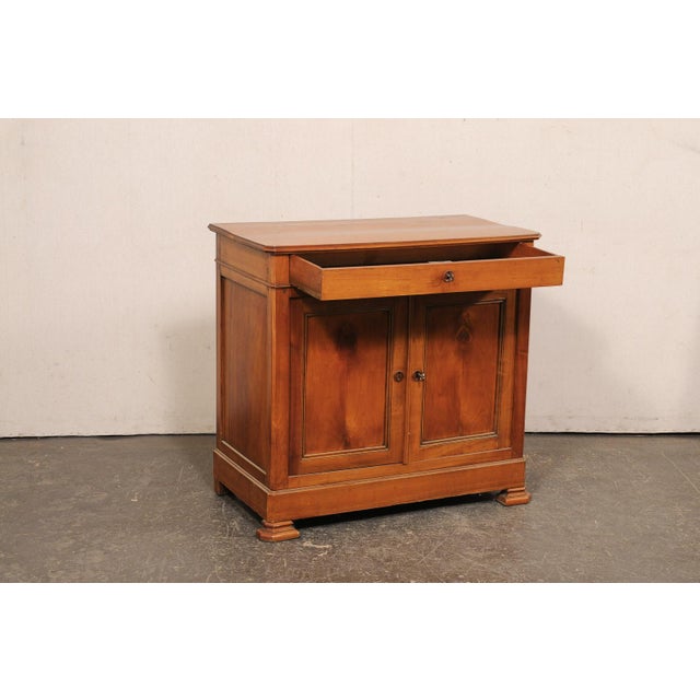 A French cherry wood cabinet from the turn of the 18th and 19th century. This antique buffet from France features a...