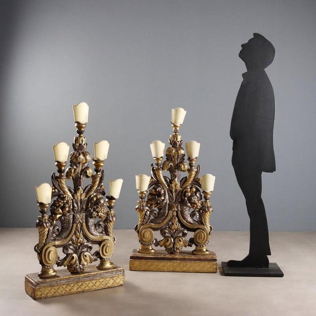 A pair of Baroque carved wooden wall torches from early 18th-century Italy. The silver leaf finish with gold mecca details...