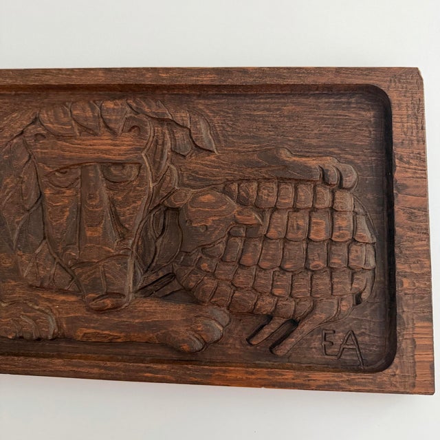 This wooden panel depicts the phrase “the lion shall lie down with the lamb” symbolizing total peace and harmony. It is...