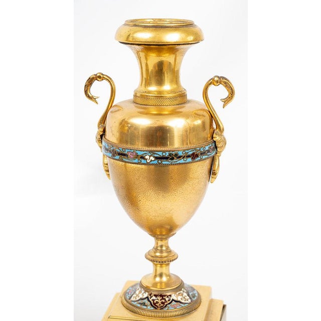 A pair of antique, double-handled vases in gilded bronze with cloisonné inlays, dating from the second half of the 19th...