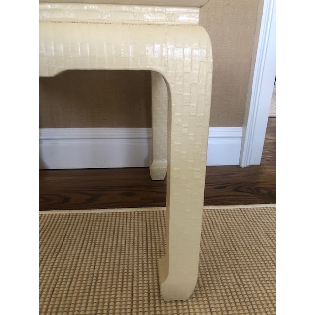 This is a beautiful ivory-colored, mid century table by Baker. It has a textured surface and a Baker label underneath.