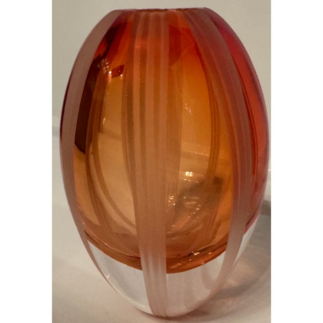 Striking modern art glass vase from the “Revolution” collection by Waterford, featuring a rich amber tone with vertical...