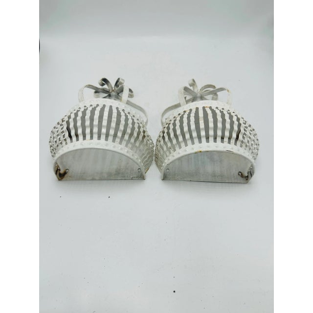 This is a charming pair of vintage metal wall sconces, likely mid-20th century, crafted in a French or Italian toleware...