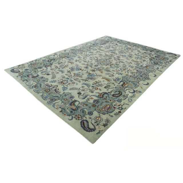 This magnificent, hand-knotted Kashan oriental rug impresses with its extraordinary color play in elegant pistachio green...