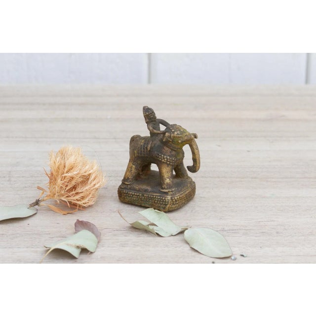 Handcrafted using glistening brass, this petite statuette features a man riding an elephant embellished with brass casted...