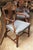 Vintage medium toned wood armchair with the shield-back silhouette originally popularized during the Neoclassical era by...