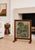 Antique needlepoint fire screen featuring a picturesque thatched cottage garden scene, hand-stitched with rich, softly...
