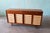 A two tone walnut and birch cabinet by Edward Wormley for Dunbar circa 1950s, part of the Janus Line. Featuring open...