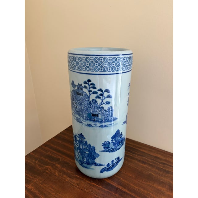 A gorgeous Chinoiserie blue and white porcelain umbrella or cane stand with Asian floral and landscape designs and birds...