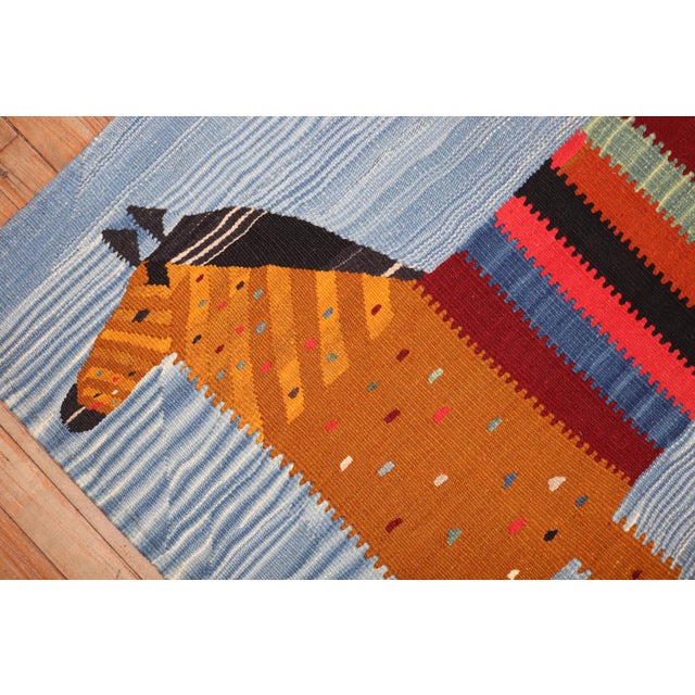 Small square size Persian Kilim from the late 20th century with a horse standing on a sky blue field Measures: 3'8'' x...