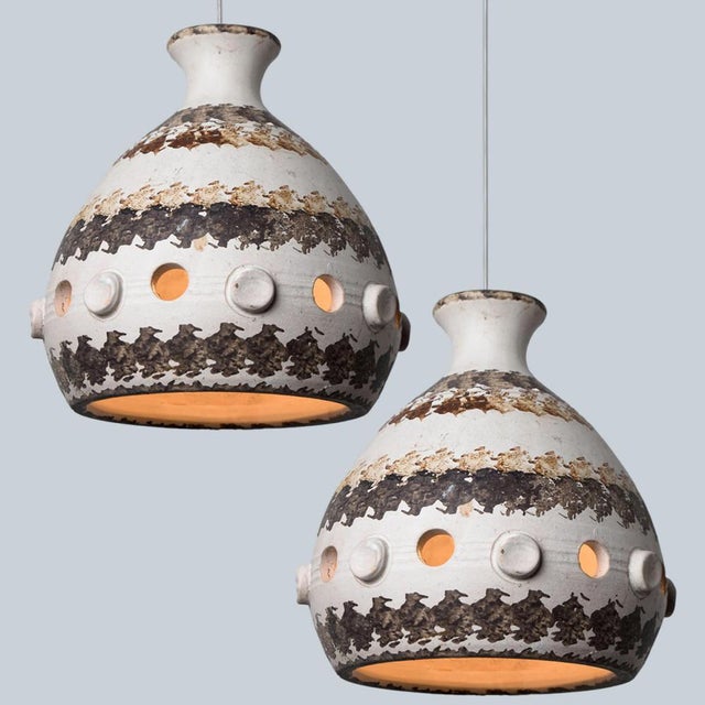 A pair of stunning round hanging lamps with an unusual shape, made with rich brown and beige striped ceramics,...