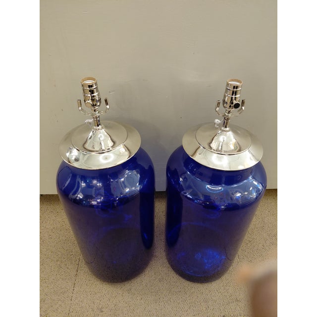 A striking pair of vintage cobalt-blue glass vessels newly converted into table lamps. Each features a generously scaled...