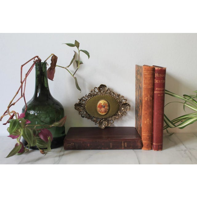 Vintage Victorian romantic porcelain cameo wall hanging with gold floral motif frame and green velvet. No makers mark....