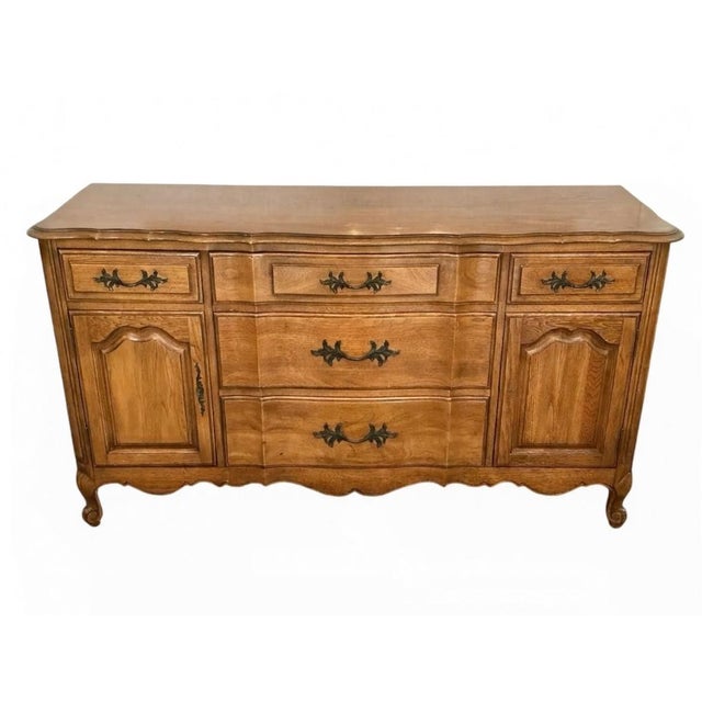 Elevate your dining or living space with this classic 1960s Thomasville French Provincial buffet. A hallmark of mid-...