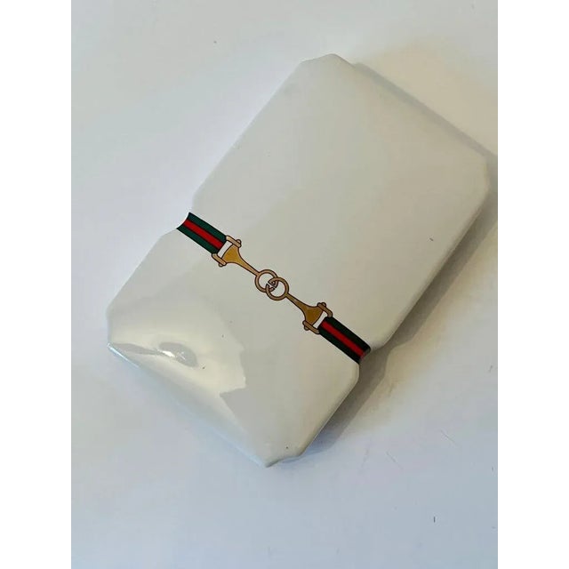 A wonderful porcelain box with the Gucci logo. Originally sold as a set for Incense, the holder is also included with some...