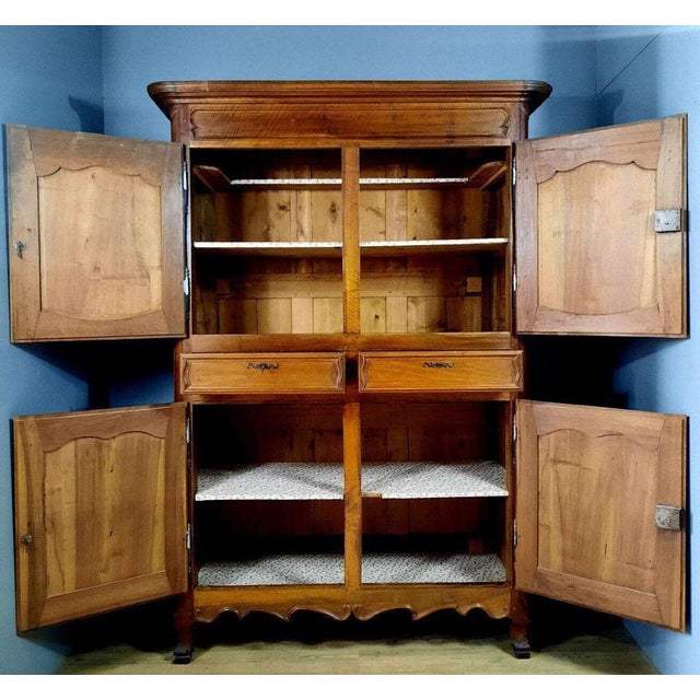 Louis XV period walnut four-leaf wardrobe circa 1750. The front opens to reveal 4 doors with moving panels and two...