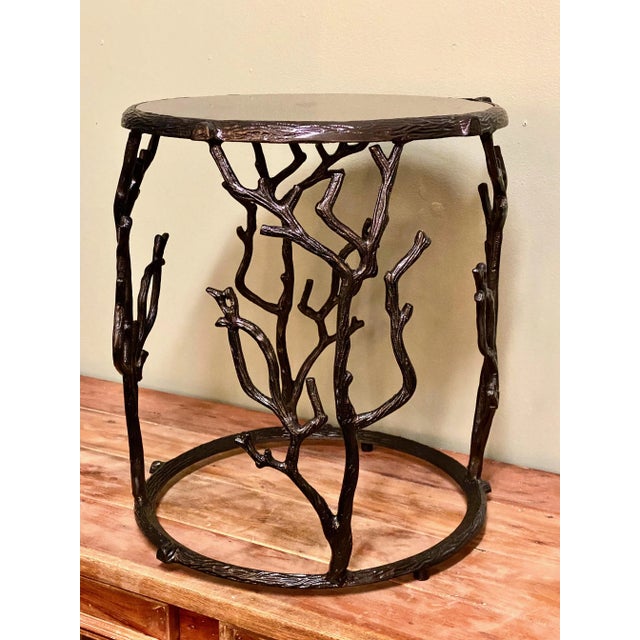 This is a charming round occasional or drinks table with a cast metal faux bois frame top with black granite. The...