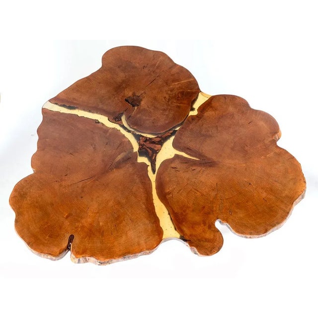 Made from three hearts of a Red Ambrosia Maple tree, this table is joined using an epoxy resin with recycled metal slugs...