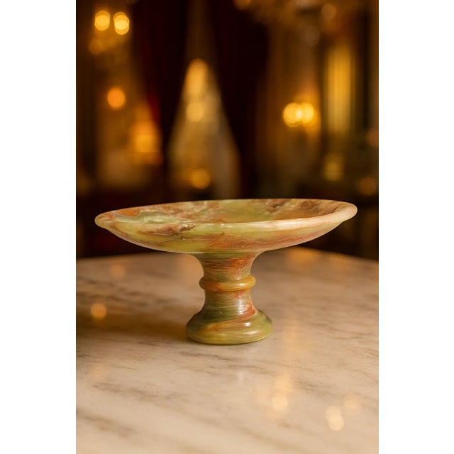 This handcrafted onyx footed bowl showcases the timeless beauty of natural stone with its striking blend of earthy green,...