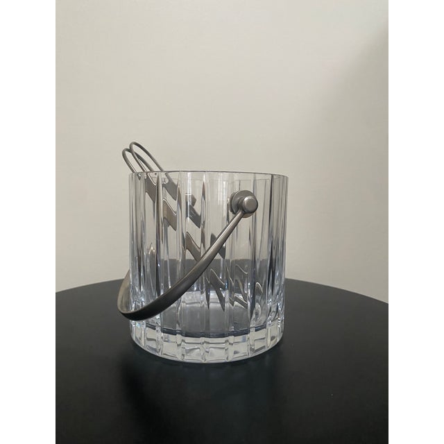 A vintage Baccarat “Harmonie” crystal ice bucket, crafted in France and distinguished by its vertical linear cut pattern...