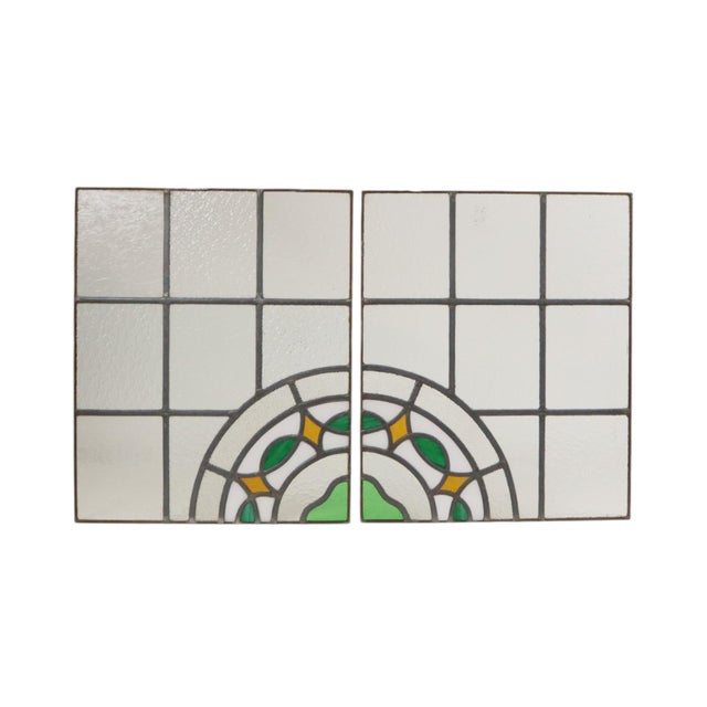 A beautiful set of two vintage stained-glass panels featuring a colorful floral pattern—designed as suncatchers—executed...