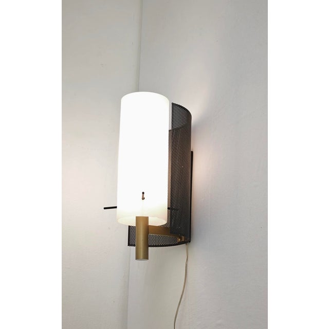 Vintage Mid-Century Modern wall lamp made in Italy in the 1950s and 1960s, commonly attributed to or created in the style...