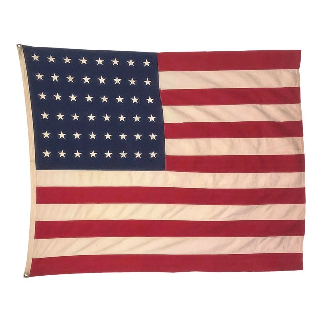 This large vintage American flag is made from a cotton cloth, with 48 embroidered stars and 13 sewn stripes. Please note...