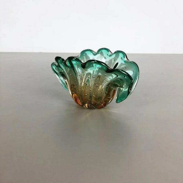 Article: Murano glass shell element Origin: Murano, Italy Decade: 1970s An elegant green brown Murano glass bowl utilizing...