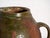 This antique two-handled glazed earthenware pot is a terracotta vessel covered with a green lead glaze. It originates from...