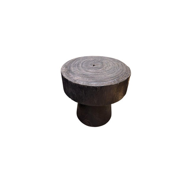 Handcrafted from solid suar wood by skilled artisans on the island of Bali, this sculptural side table celebrates the raw...