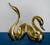 A commanding pair of monumental Hollywood Regency brass swan sculptures with exceptional sculptural styling and dramatic...