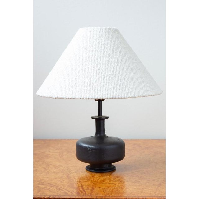 Brutalist table lamp designed and made in Scandinavia. Made during the 1950-60s. Solid rough surfaced cast iron lamp base...