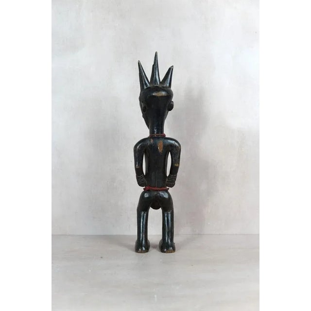 Carved from indigenous wood, this figure originates from the Songye people of the Democratic Republic of Congo. Known as...