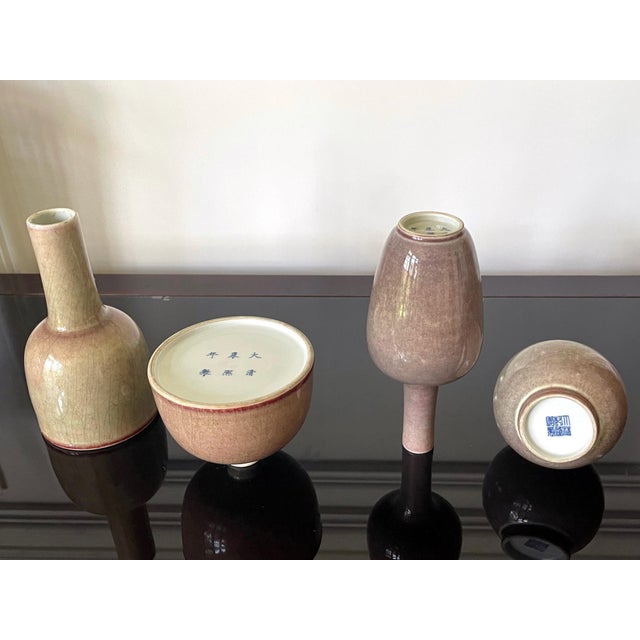 An American Midwest collection of four small Chinese ceramic vases covered in peach-bloom glaze circa Qing Dynasty, 19th...