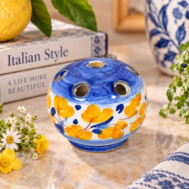 Charming vintage Italian ceramic flower frog, hand-painted in a cheerful palette of cobalt and soft blue with golden...