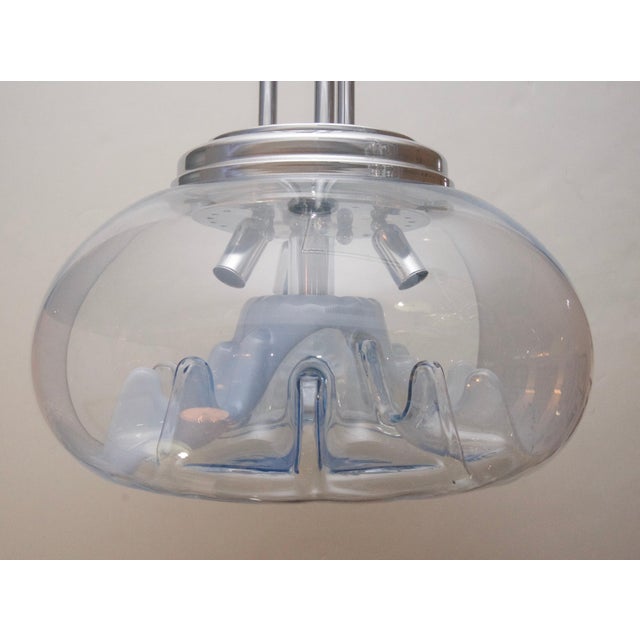 This stylish and chic Mazzega chandelier dates to the 1950s-1960s. The piece is fabricated in colorless, blue and white...