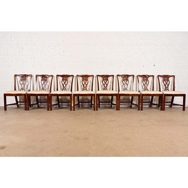 A gorgeous set of eight Georgian or Chippendale style dining chairs By Maitland Smith Late 20th Century Carved mahogany...