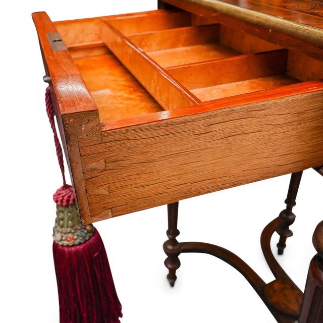 DESCRIPTION: Antique French vanity table featuring partially fluted legs, a single drawer with bird's eye maple veneered...