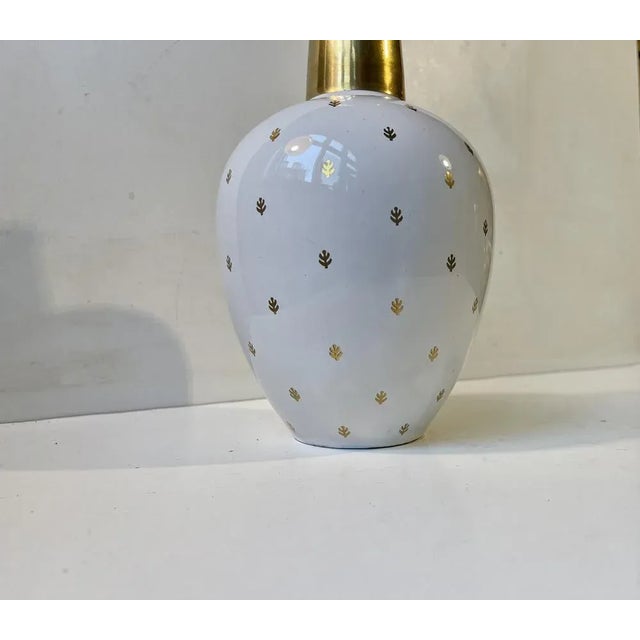 A stylish ovoid ceramic vase decorated with gold glaze on a white main body. Un-identified Scandinavian/German...