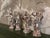 A lovely and whimsical set of four frolicking figures of a young Bacchus on stepped and chamfered bases. One figure is...