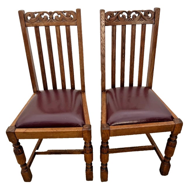 Bring timeless character to your dining space with this matching pair of vintage solid oak chairs. Featuring classic...