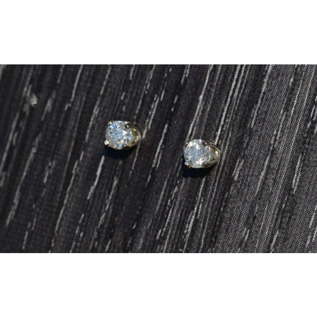 Ladies 14K White Gold Diamond Stud Earrings. Crafted in 14 karat white gold, these diamond studs feature a total diamond...