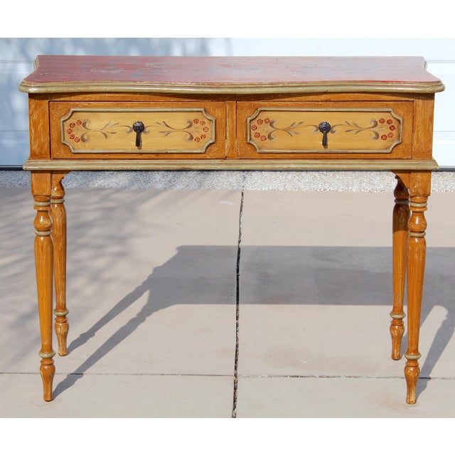 This striking Italian Florentine-style console table showcases the charm and artistry of traditional European...