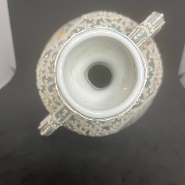 This beautiful Japanese porcelain bottle vase features intricate raised moriage decoration covering nearly the entire...