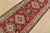 A tribal Caucasian Kazak runner hand-knotted with fine wool on a cotton foundation. This rug features geometric medallions...