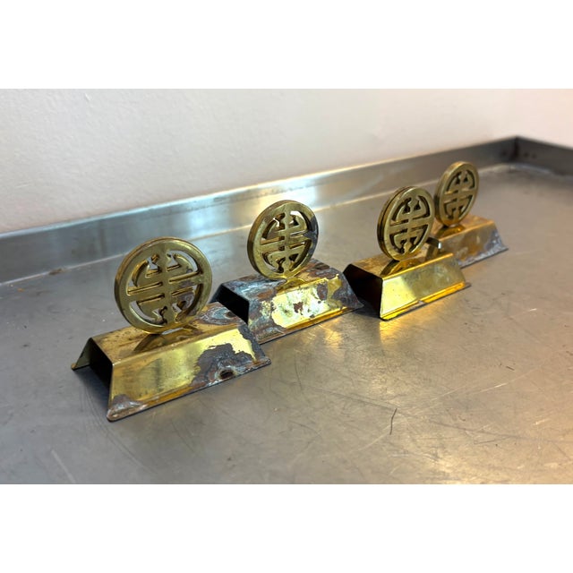 1950s-60s brass asian medallion place card holders; set of 4. Some patina to metal throughout as shown.