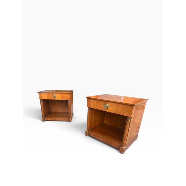 Elegant pair of vintage Baker Furniture Neoclassical nightstands, dating to approximately the 1960s and retaining their...