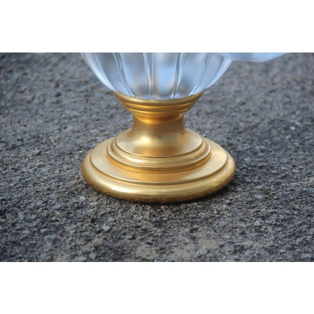 This is a raised bowl with a scalloped brass foot and 24-karat gold brass.