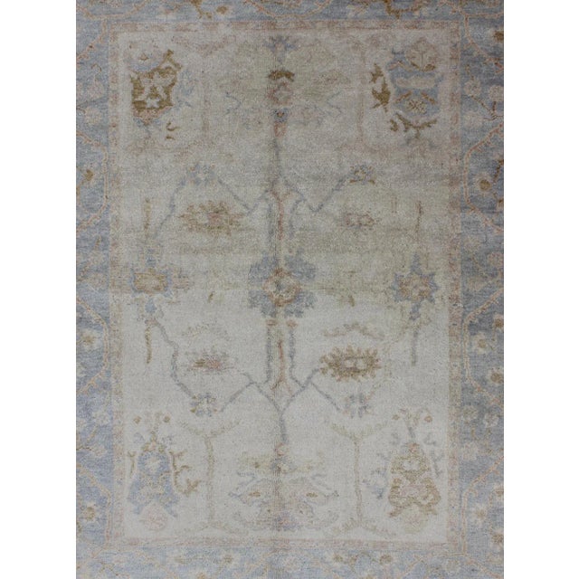 Muted Oushak hand knotted rug in light blue, ivory/white & light brown, Rug/, country of origin / type: India / Oushak...