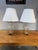 Beautiful vintage pair of Hollywood Regency style cut crystal and brass table lamps with white pleated silk shades. The...